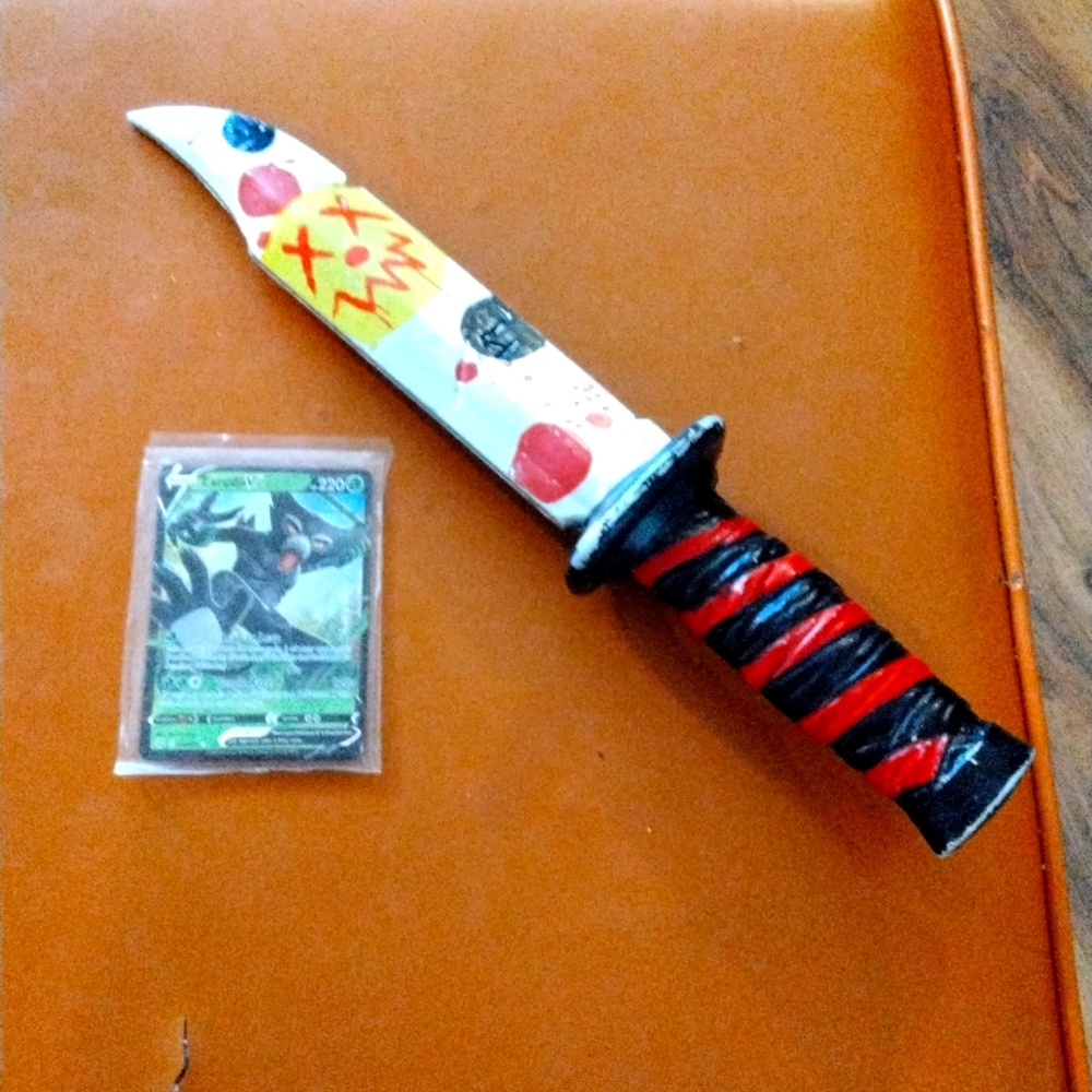 A dagger and a zarude v card